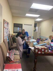 Office staff wrapping presents at TenderHeearted Home Care